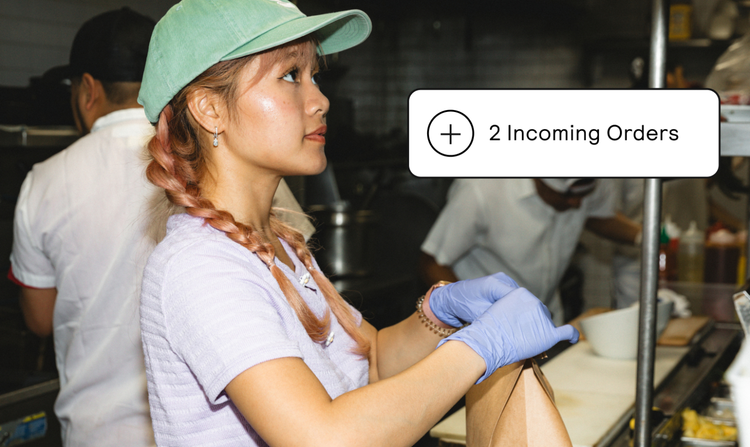 A restaurant employee prepares a paper bag of food for takeout.