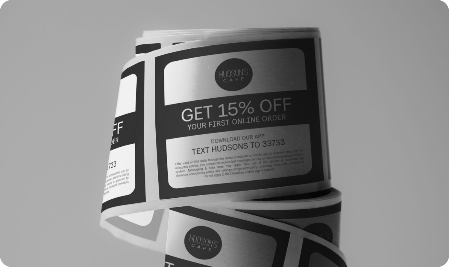 A roll of unused promotional labels for a restaurant
