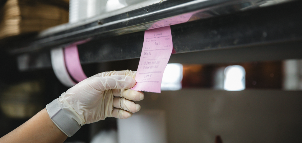 hand grabbing ticket in restaurant