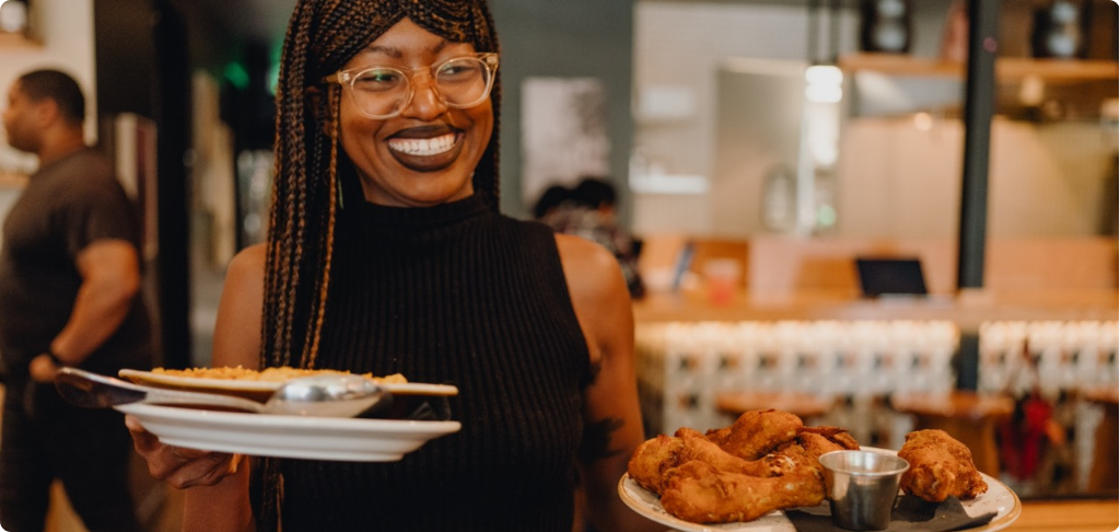 Server at Alta Adams bringing food to a table