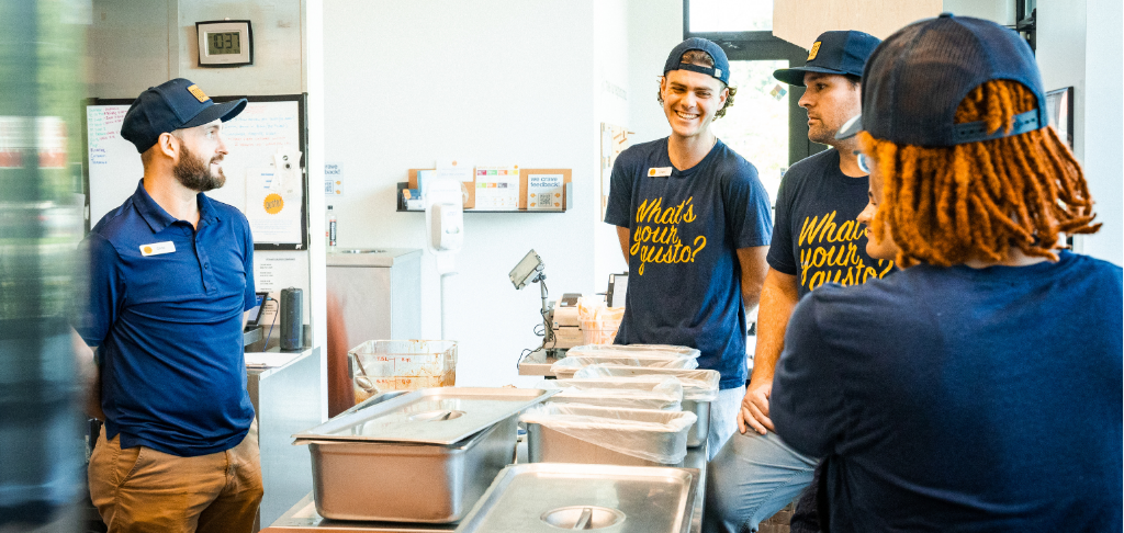 Pre-shift meeting for scheduled restaurant employees