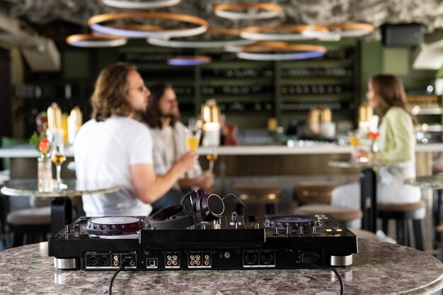 music player in forefront with people sitting behind