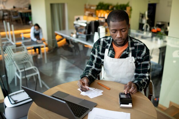 person doing calculations at table in restaurant