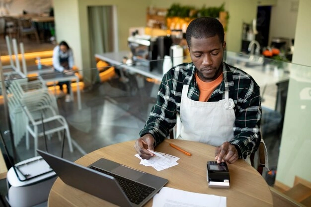 person doing calculations at table in restaurant
