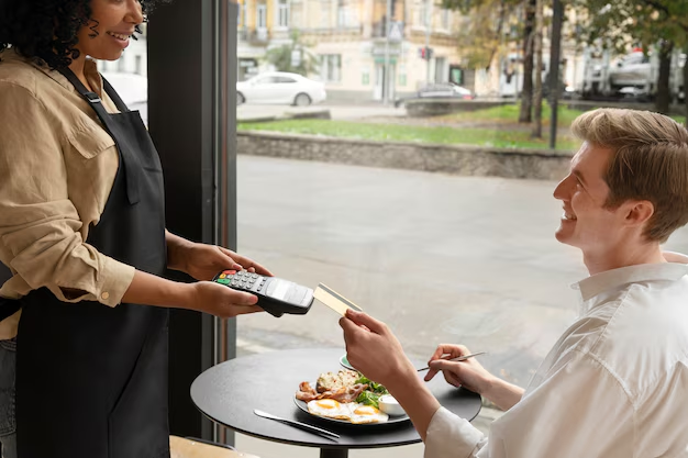 person paying for restaurant meal with credit card