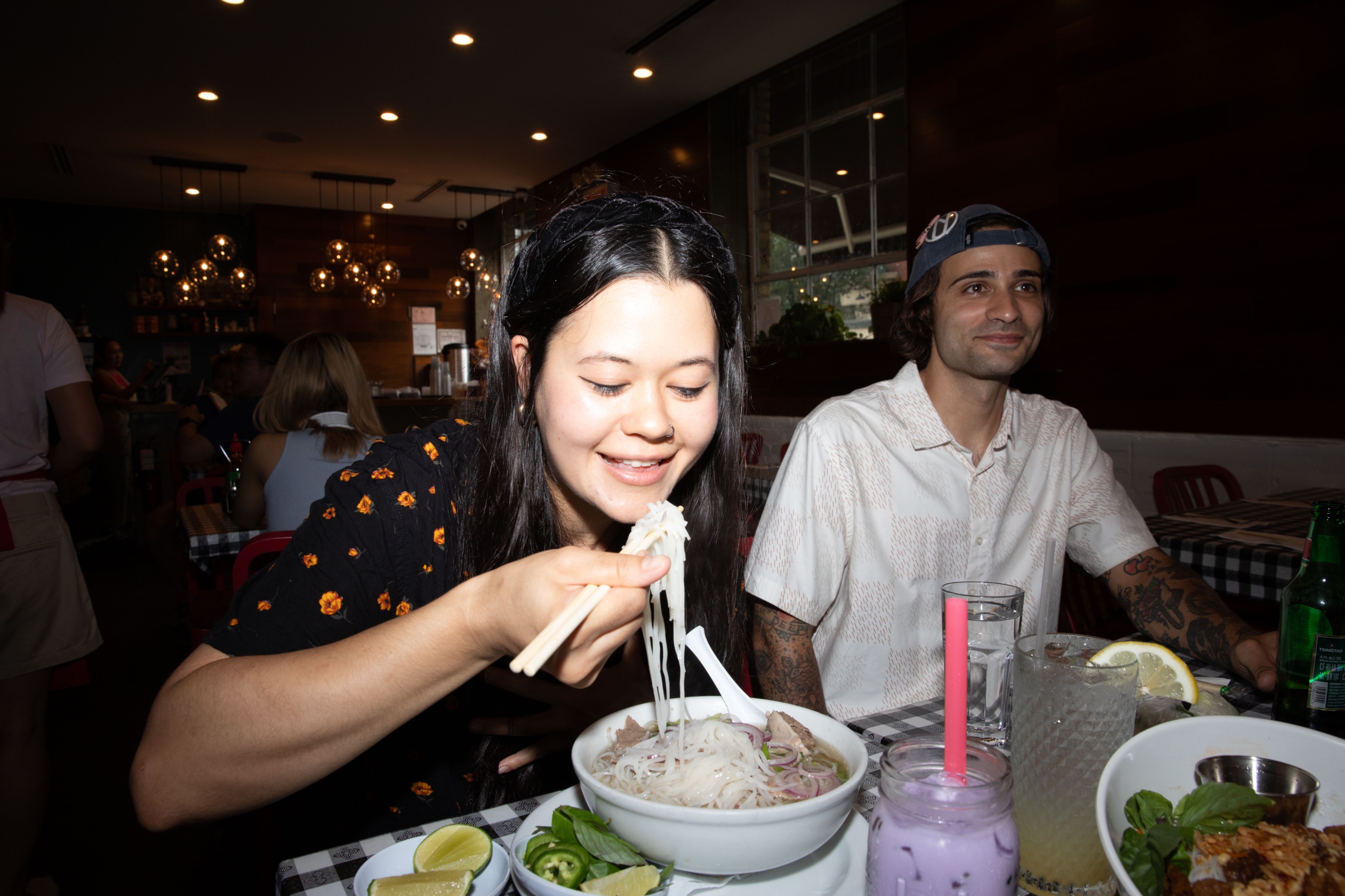 person eating noodles at a restaurant