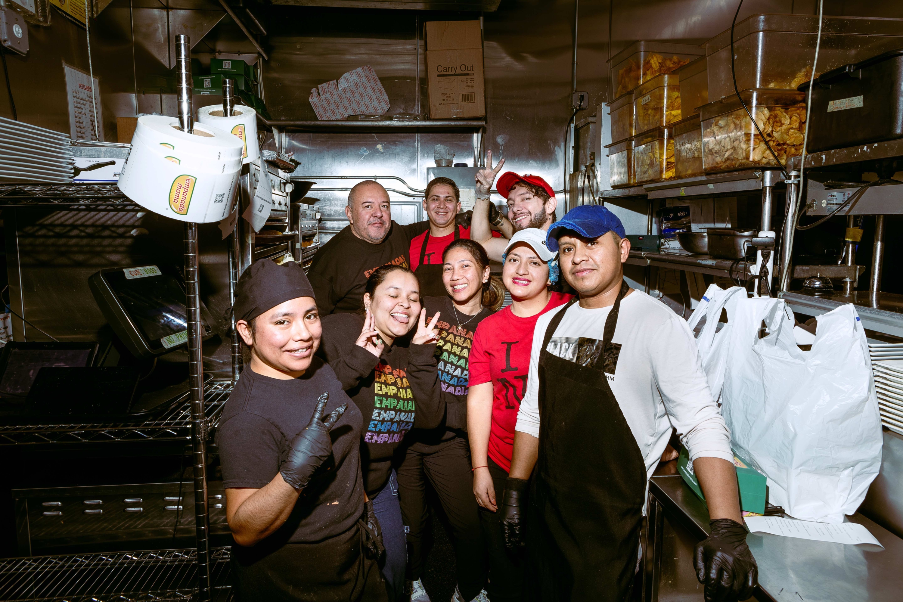 restaurant staff gathered together in kitchen
