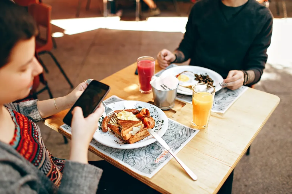 diner taking photo of breakfast food