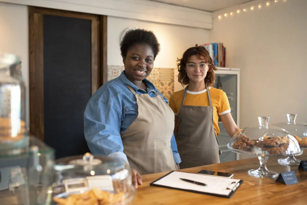 Restaurant staff standing behind the counter before opening, representing pre-launch planning and early discovery in a new restaurant marketing strategy. 