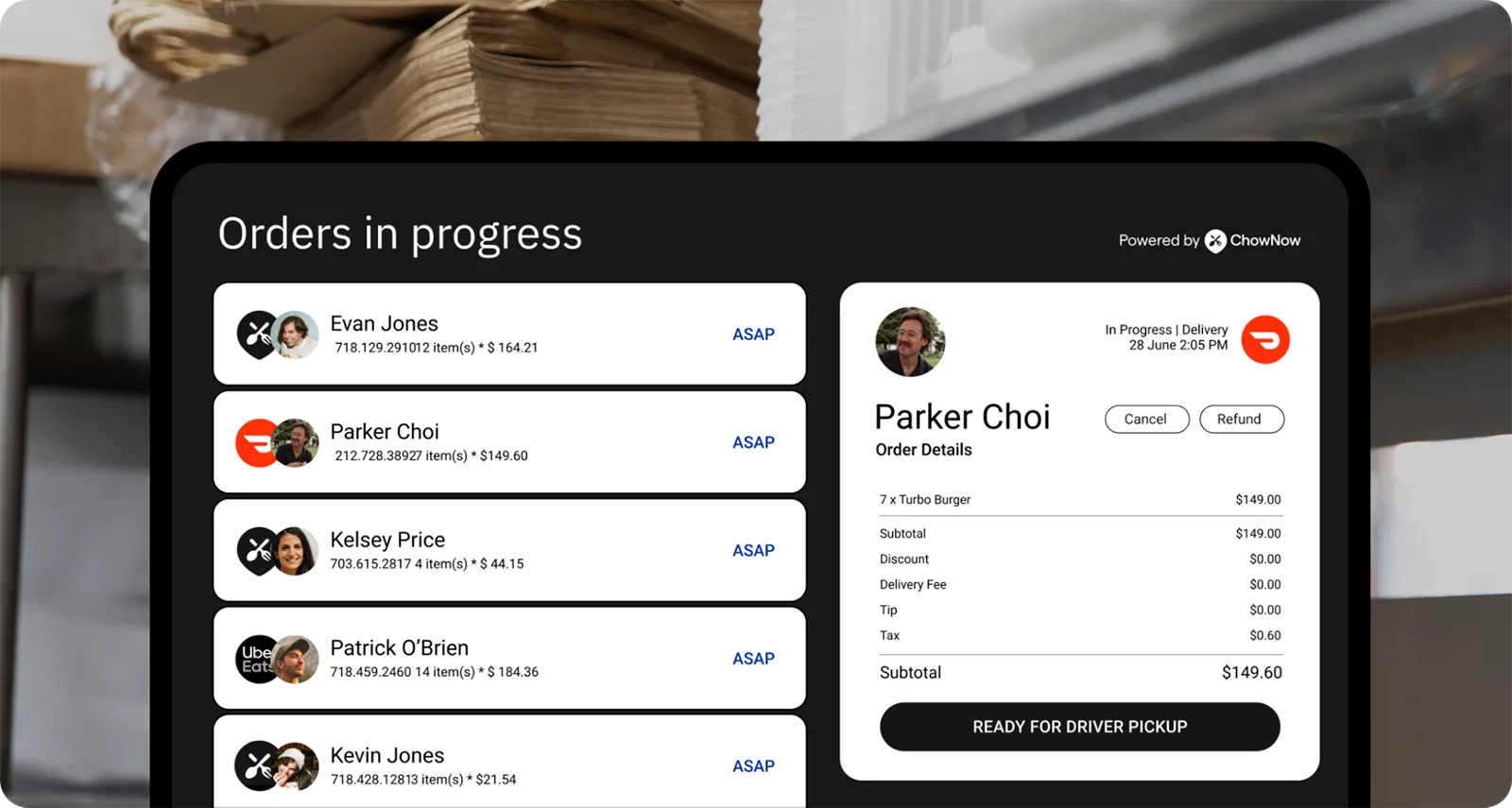 A restaurant order management screen showing “Orders in progress,” with multiple customer orders (ASAP) and a selected delivery order for Parker Choi, including item list, totals, and a “Ready for driver pickup” status, powered by ChowNow.